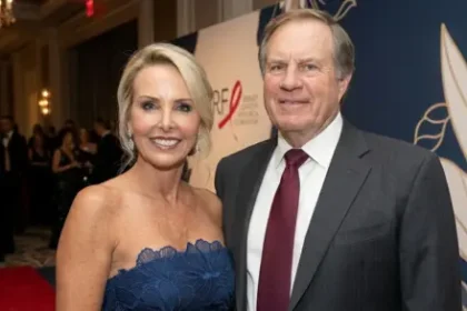 Debby Clarke Belichick standing confidently in a serene outdoor setting, reflecting her calm, private, and composed personality.