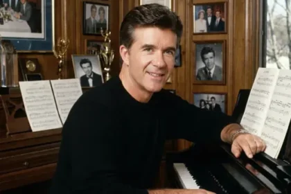 Burt Thicke sitting at a piano, playing music with focus and concentration