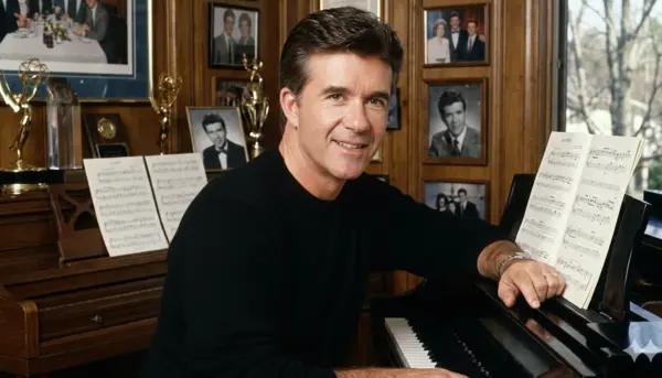 Burt Thicke sitting at a piano, playing music with focus and concentration